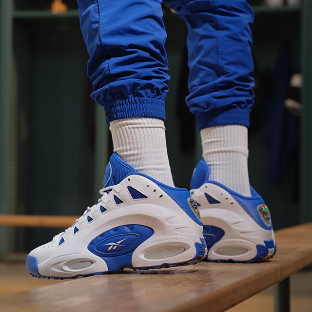 Side view of Emmitt Smith's blue and white Reebok sneakers.